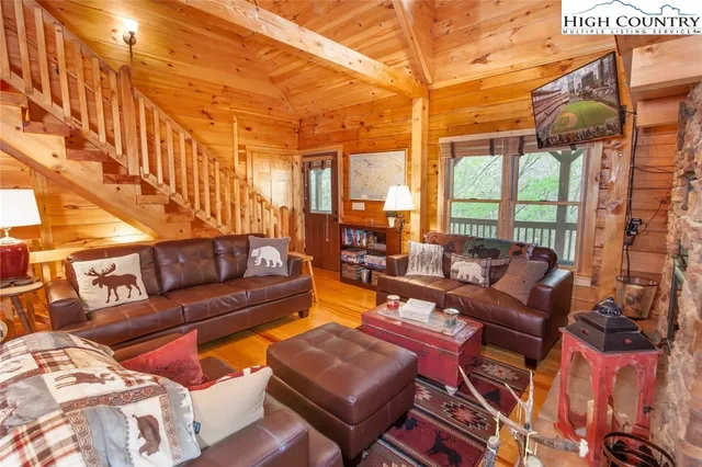 a living room with furniture and a floor to ceiling window