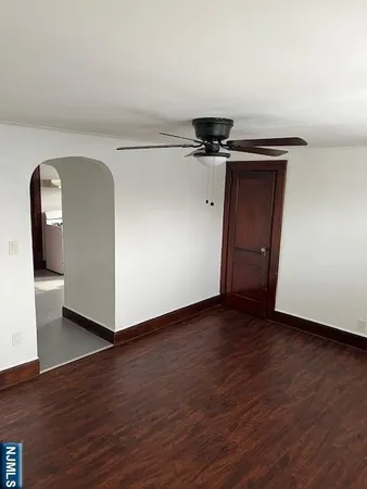 a view of a livingroom with wooden floor and a sink