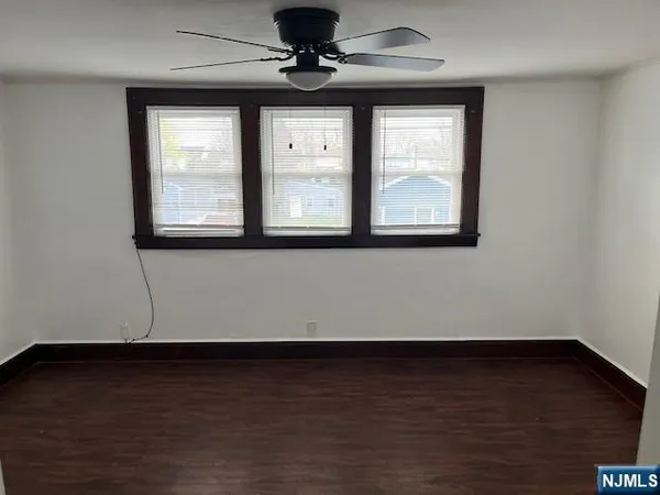 a view of a room with wooden floor and window