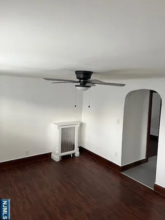 a view of a livingroom with wooden floor and a window