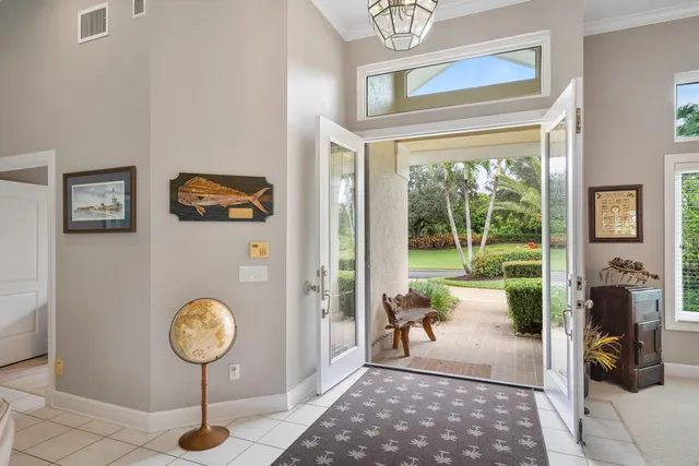 a living room with furniture a large window and a chandelier