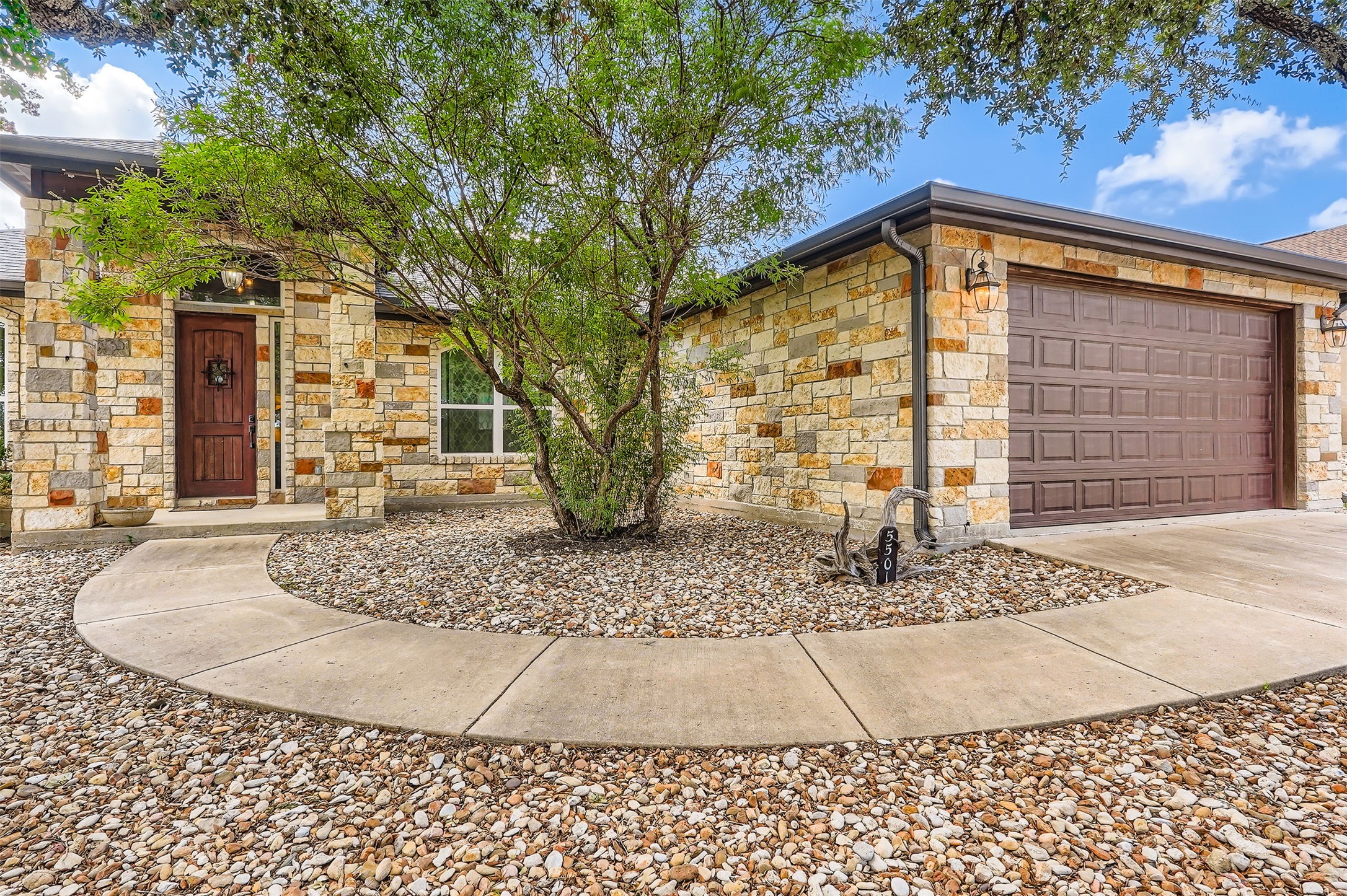 5501 Hitching Post Lago Vista, TX 78645 - Photo 2 of 26 a view of a house with a patio