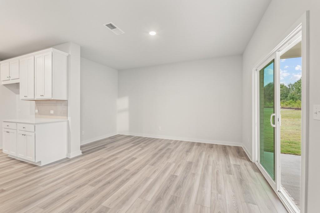 6725 Settingdown Crk Drive Dawsonville, GA 30534 - Photo 20 of 41 a view of empty room with wooden floor and fan