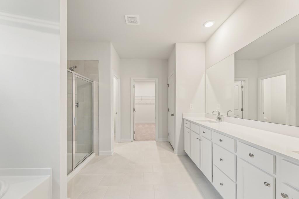 6725 Settingdown Crk Drive Dawsonville, GA 30534 - Photo 23 of 41 a spacious bathroom with a double vanity sink a mirror and a shower