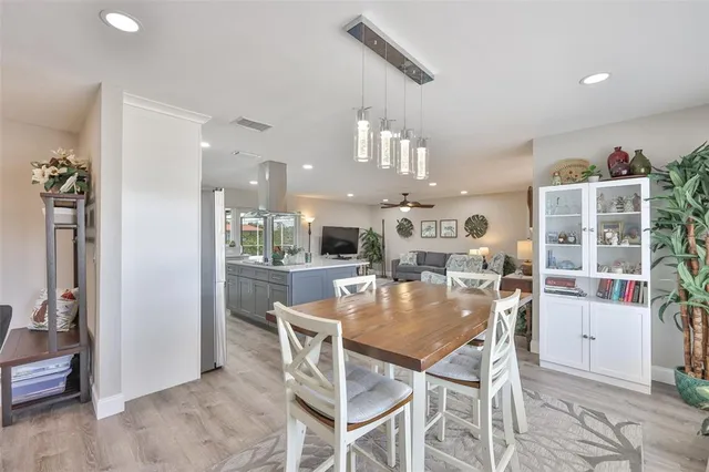 a large kitchen with a lot of counter space and a wooden floor