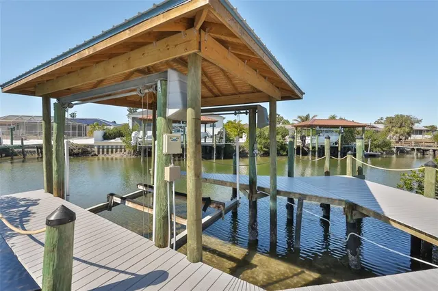 an aerial view of a house with a yard and lake view