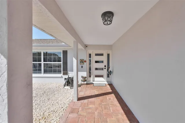 a kitchen with stainless steel appliances kitchen island granite countertop a refrigerator a stove a sink a dining table and chairs with wooden floor