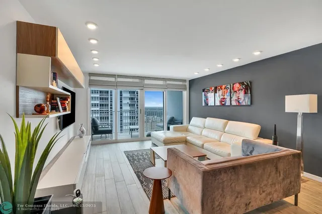 a kitchen with stainless steel appliances granite countertop a refrigerator a stove and a sink