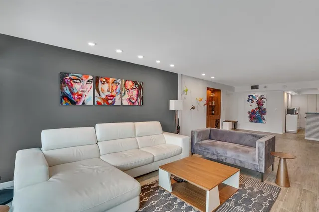 a living room with furniture and a floor to ceiling window