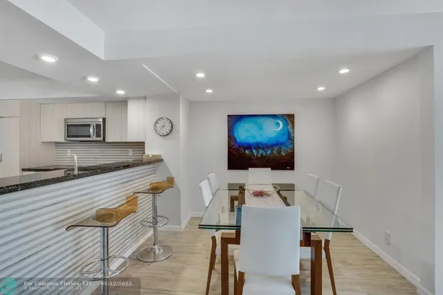 a spacious bedroom with a bed and a flat screen tv