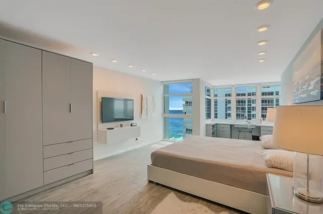 a bedroom with a bed and a potted plant