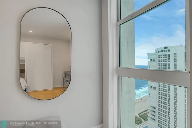 a living room with furniture and a floor to ceiling window