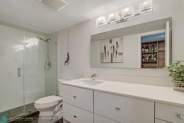 a kitchen with stainless steel appliances kitchen island granite countertop a sink a stove and a refrigerator