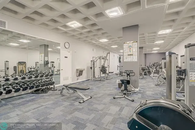 a white building with a swimming pool in front of it