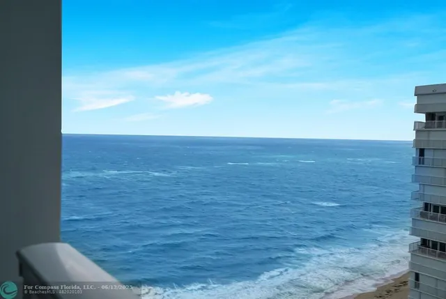 a living room with furniture and a book shelf