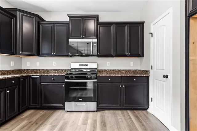 a kitchen with wooden cabinets and stainless steel appliances