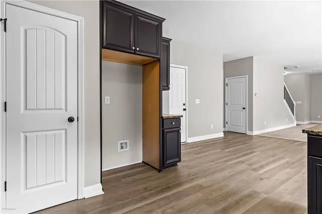 an empty room with wooden floor and closet