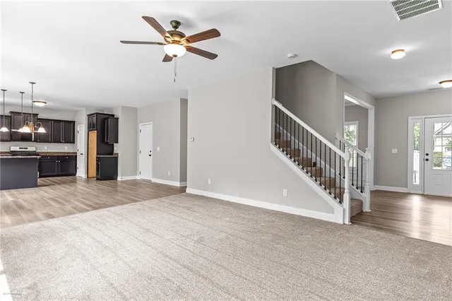 a view of an empty room with a kitchen