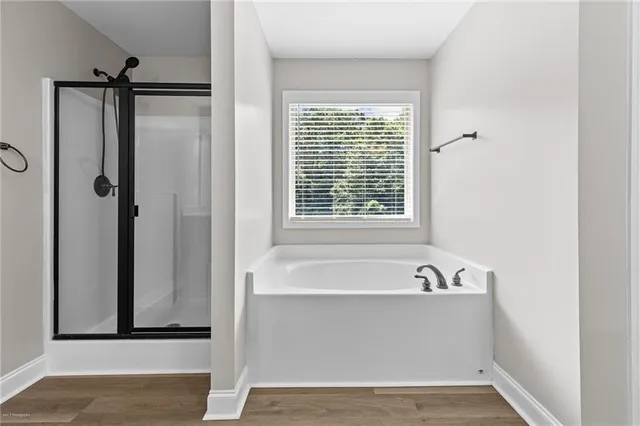 a bathroom with a bathtub and a shower