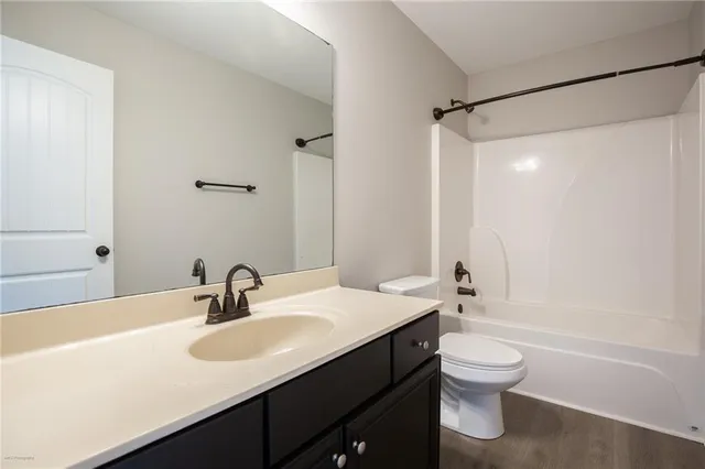 a bathroom with a sink toilet tub and shower