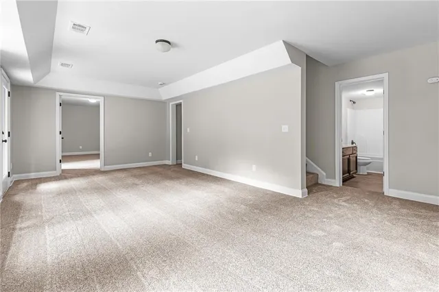 an empty room with closet and a bathroom