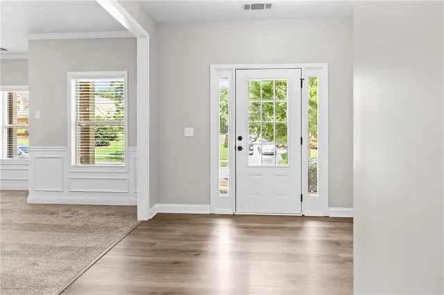 an empty room with window and wooden floor