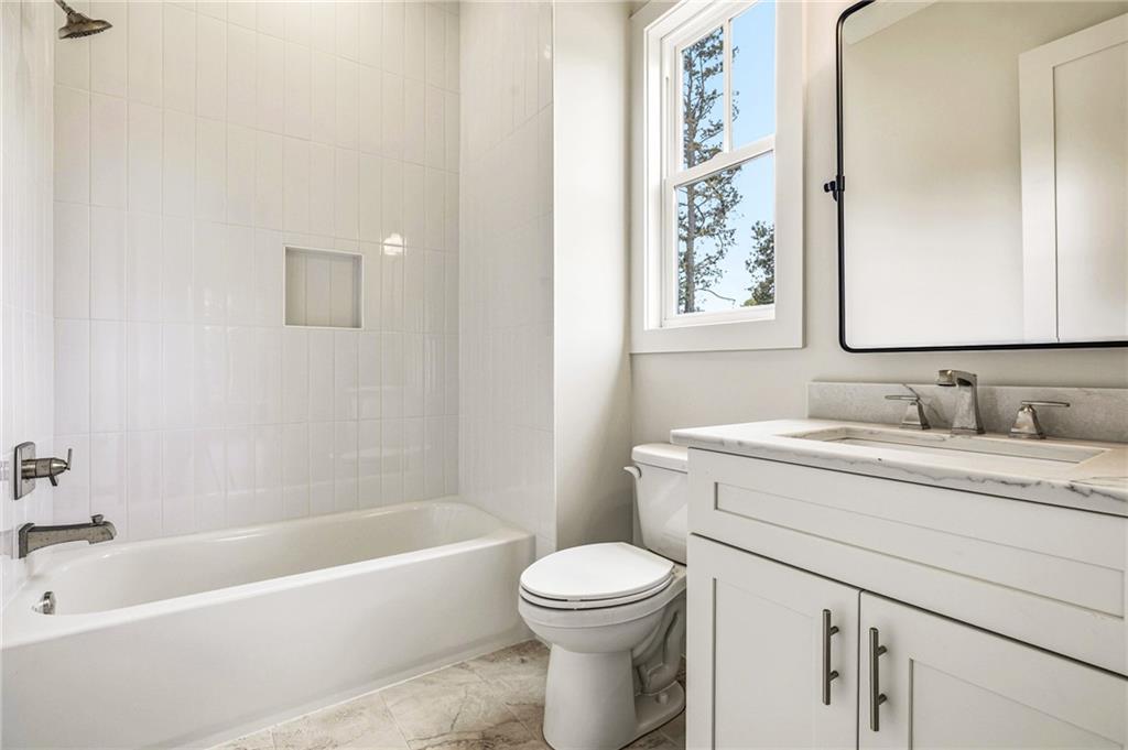 1967 Highgrove Court Decatur, GA 30033 - Photo 46 of 60 a bathroom with a granite countertop sink a toilet and a bathtub