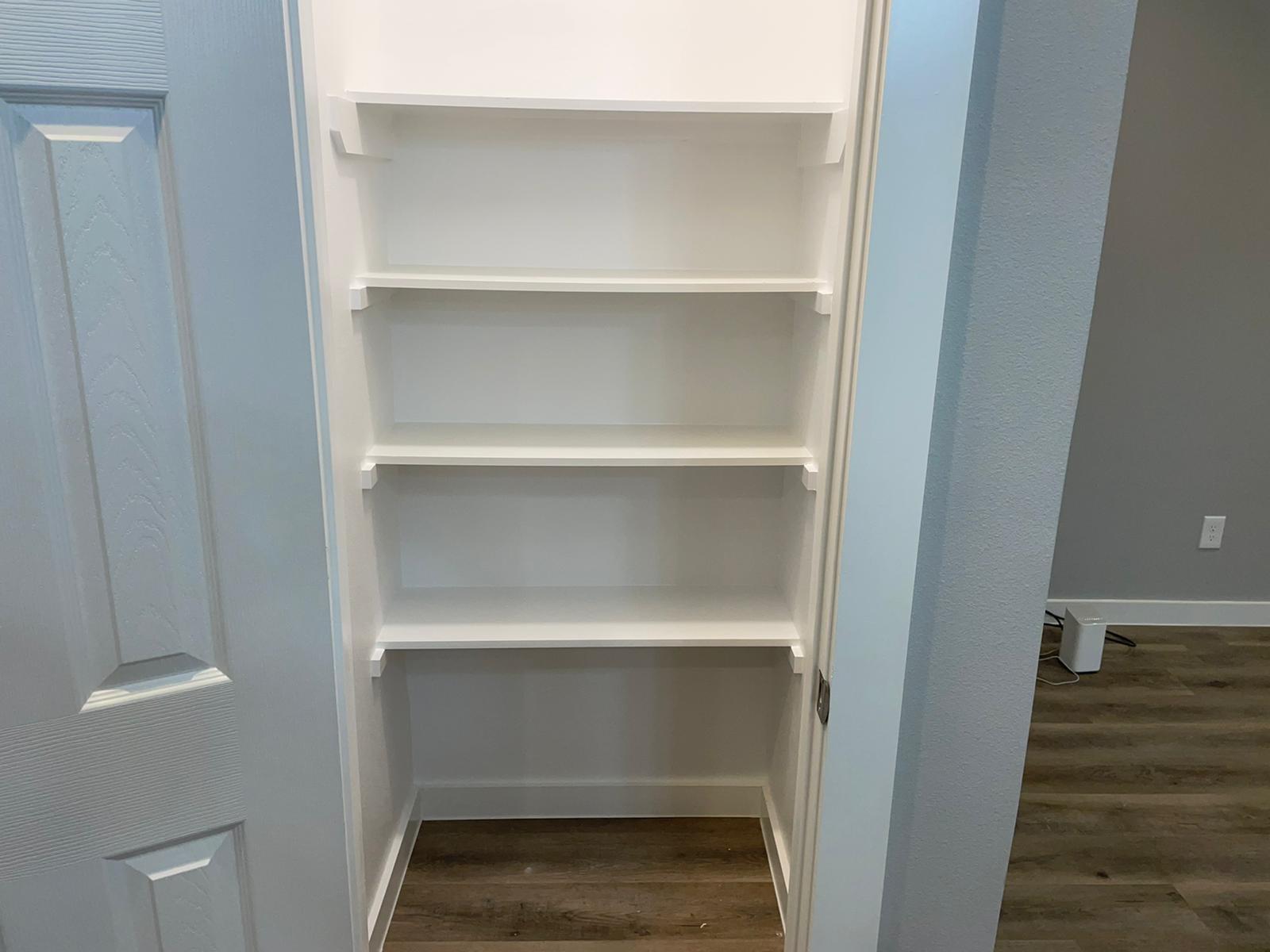 9114 Caddo Road, Unit A & B Houston, TX 77078 - Photo 20 of 24 Pantry with built-in shelving and wood-look flooring enhance this dedicated storage area.