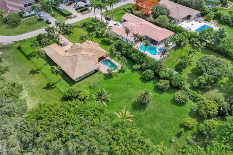 an aerial view of a house with a yard