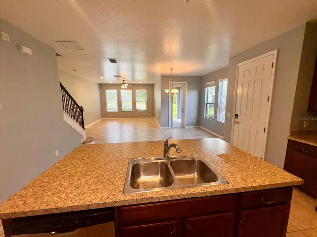 a kitchen with a sink and a refrigerator