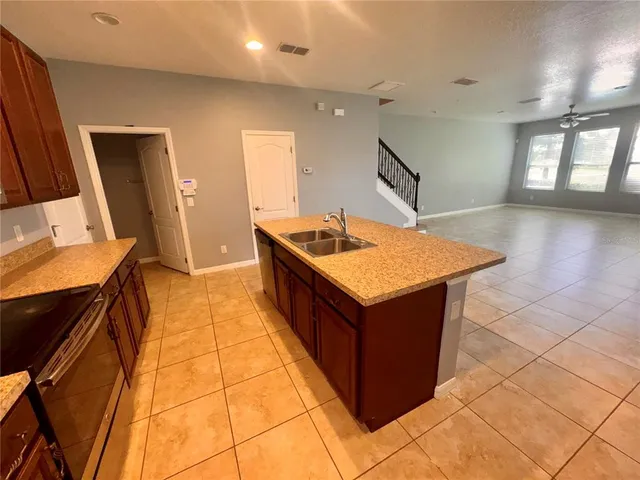 a kitchen with stainless steel appliances granite countertop a stove and a sink