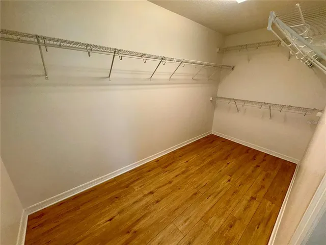 a view of a room with wooden floor