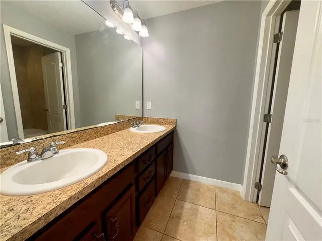 a bathroom with a granite countertop sink a mirror and a vanity