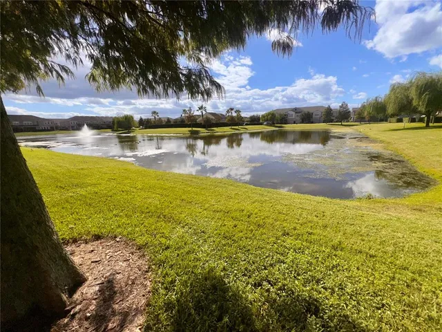 an empty room with windows and ceiling fan