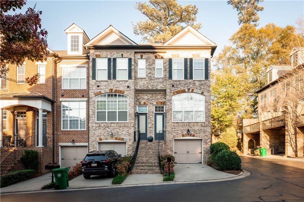 2661 Rivers Edge Drive Northeast Atlanta, GA 30324 - Photo 1 of 1 a front view of a residential apartment building with a yard