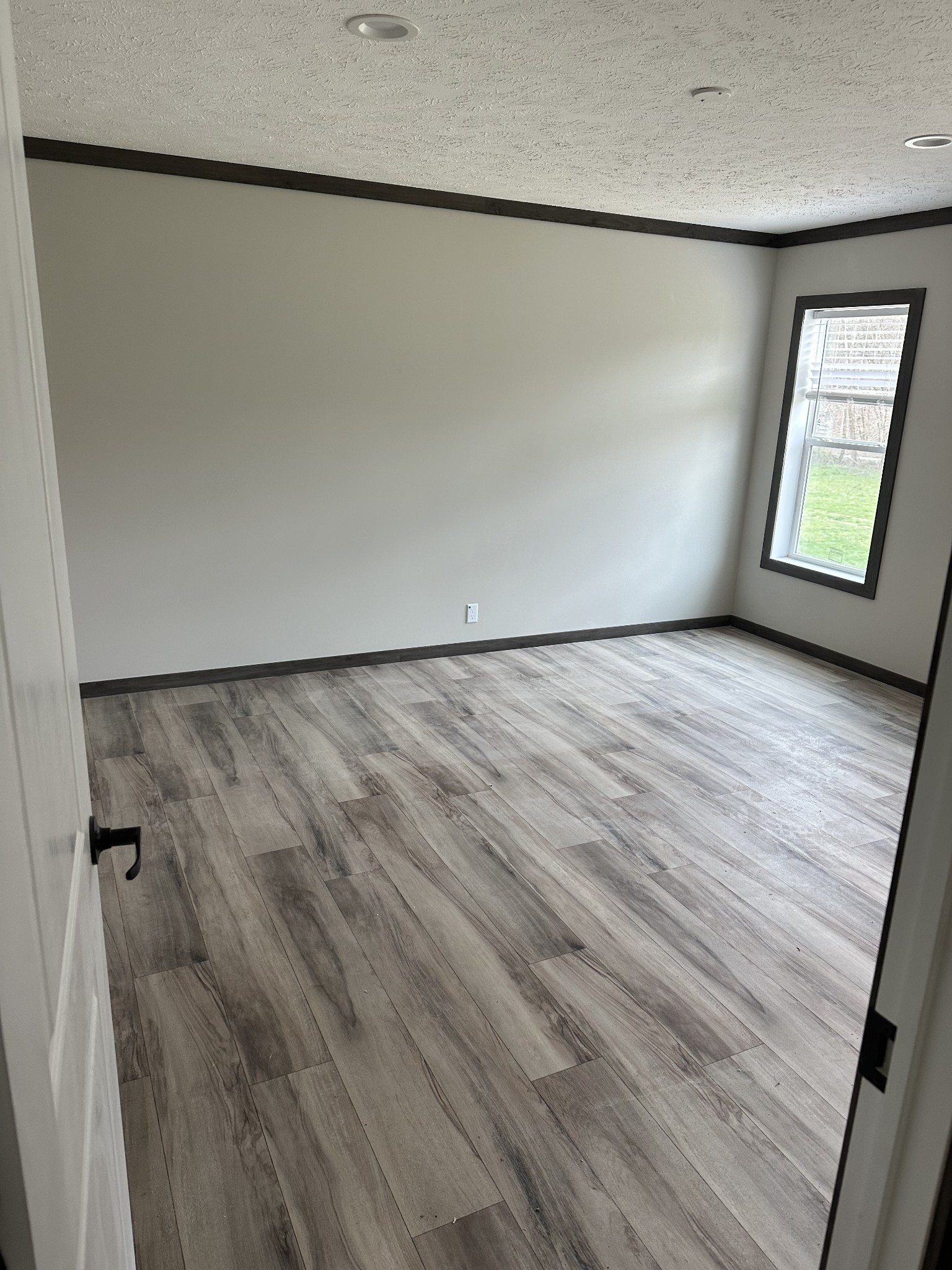 3340 Wixtown Road Westmoreland, TN 37186 - Photo 16 of 27 a view of an empty room with a window and wooden floor