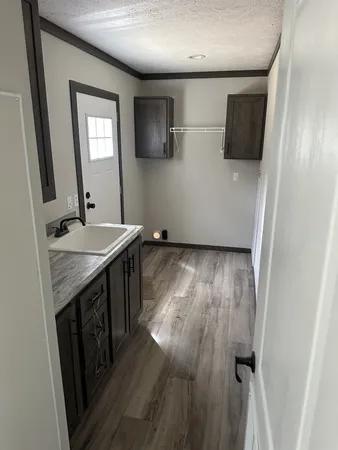 a kitchen with a refrigerator and a stove top oven