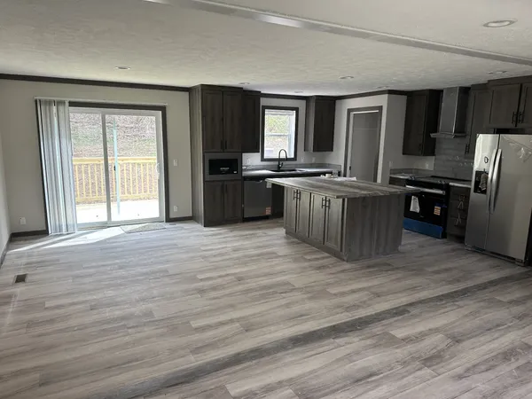 a view of empty room with wooden floor and window