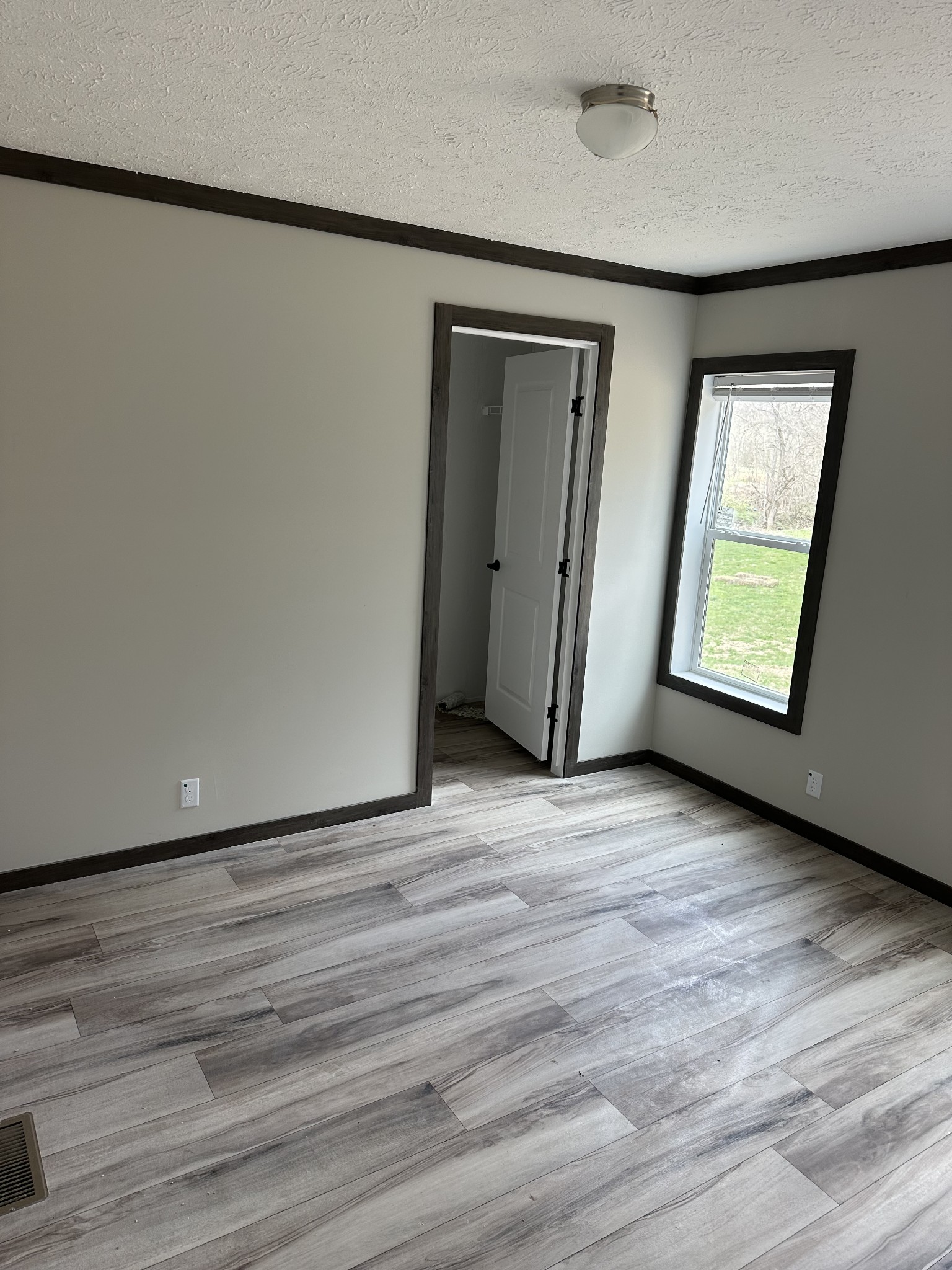 3340 Wixtown Road Westmoreland, TN 37186 - Photo 27 of 27 a view of an empty room with wooden floor and a window
