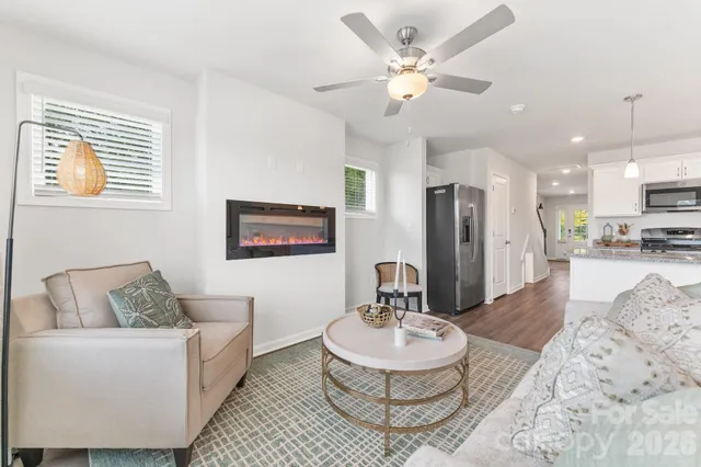a living room with furniture and a dining room