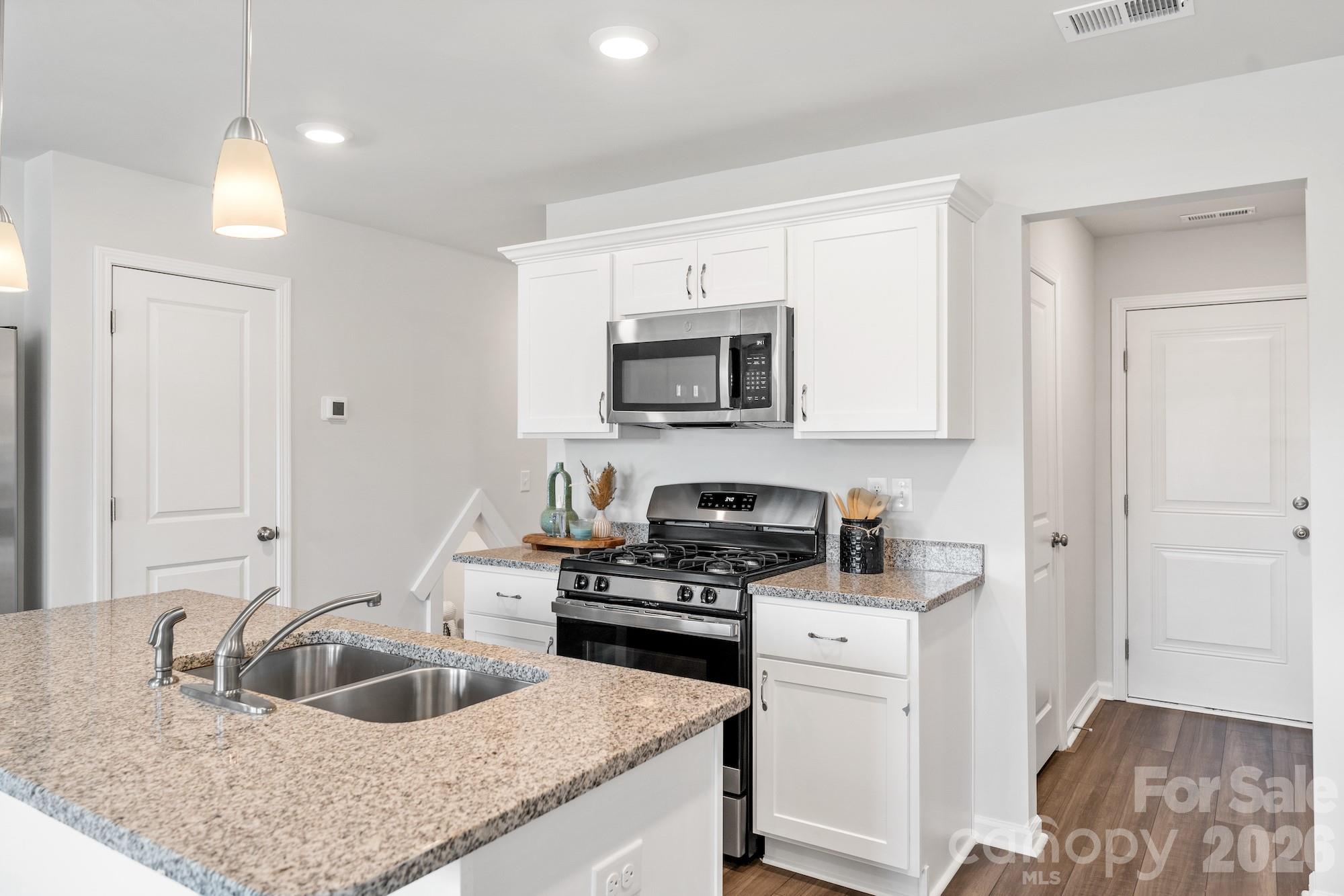 3005 Kingsfield Road, Unit 46 Charlotte, NC 28208 - Photo 12 of 15 a kitchen that has a sink and a stove top oven