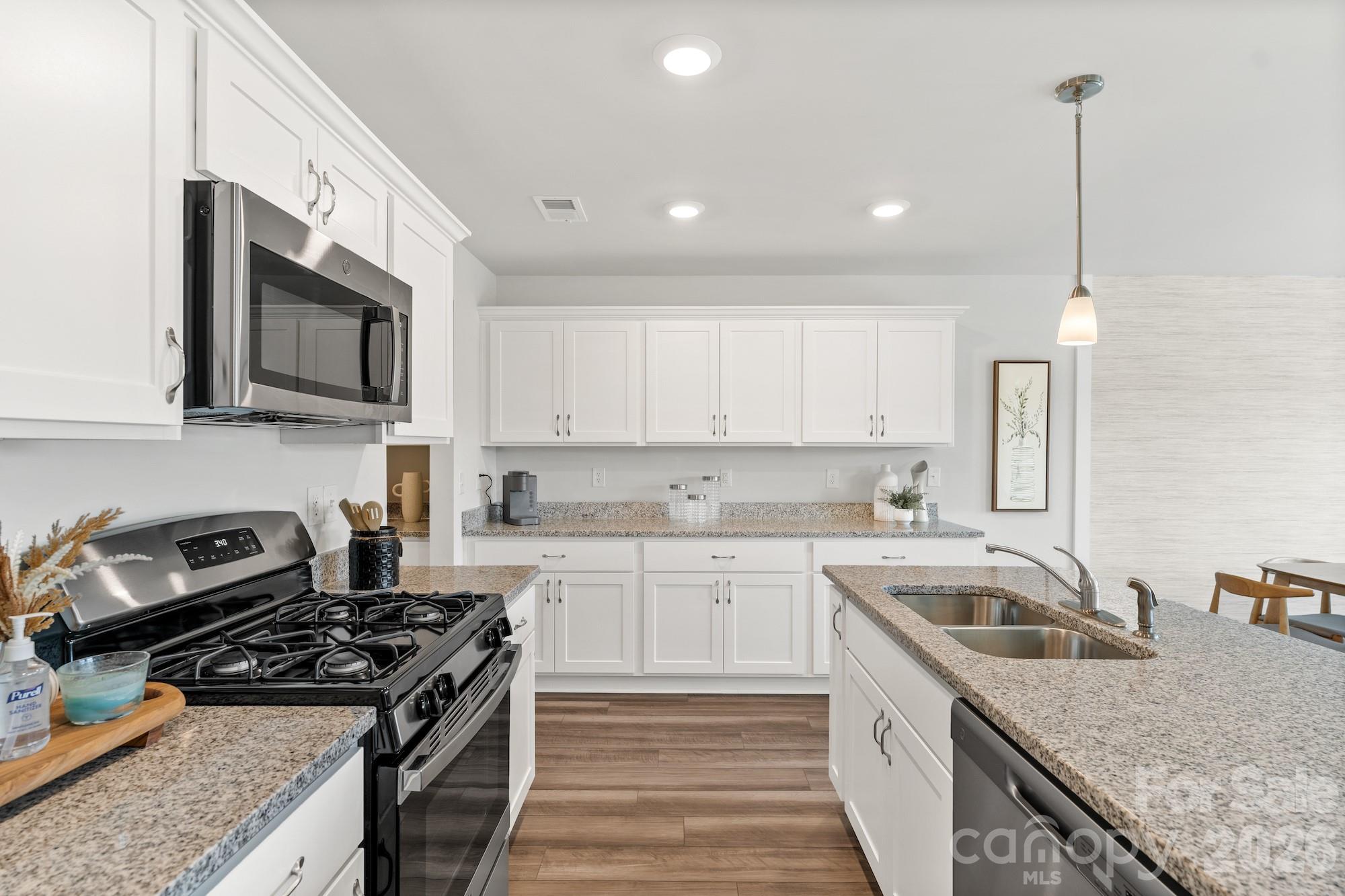 3005 Kingsfield Road, Unit 46 Charlotte, NC 28208 - Photo 13 of 15 a kitchen with stainless steel appliances granite countertop a sink stove and cabinets