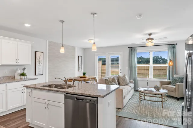 a kitchen with sink refrigerator and window