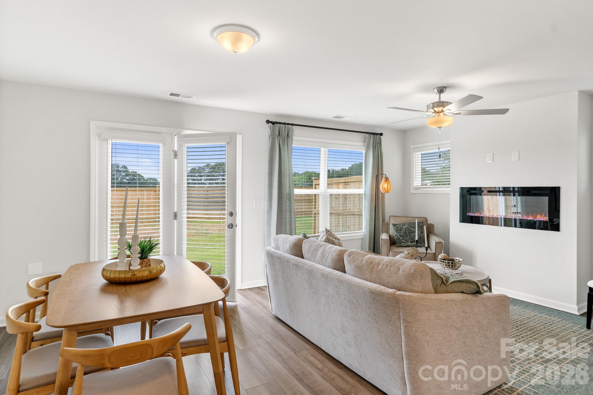 3005 Kingsfield Road, Unit 46 Charlotte, NC 28208 - Photo 7 of 15 a living room with furniture a flat screen tv and a large window