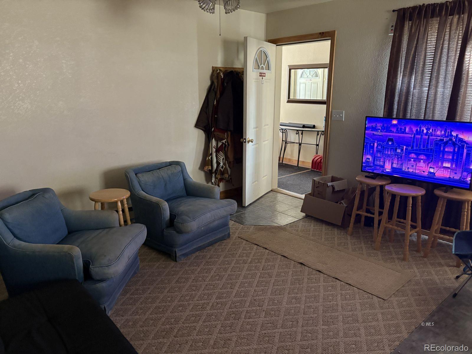 702 Main Street Silver Cliff, CO 81252 - Photo 9 of 20 a living room with furniture and a flat screen tv