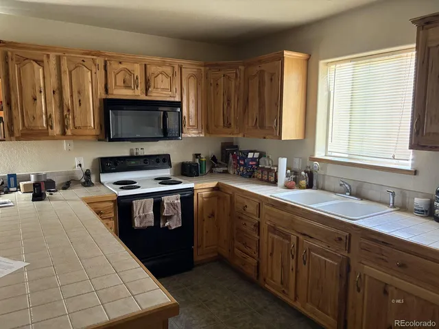 a kitchen with stainless steel appliances a stove sink microwave and cabinets