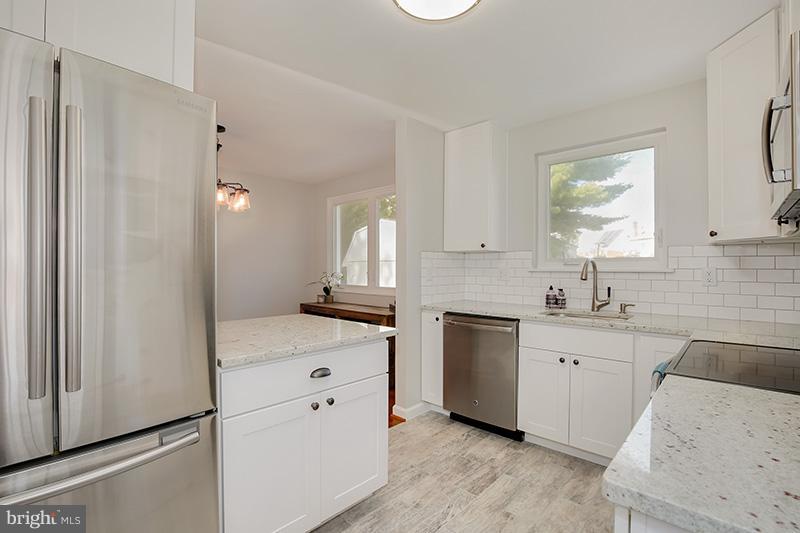 3807 Jeffry Street Silver Spring, MD 20906 - Photo 11 of 26 a kitchen with white cabinets and sink