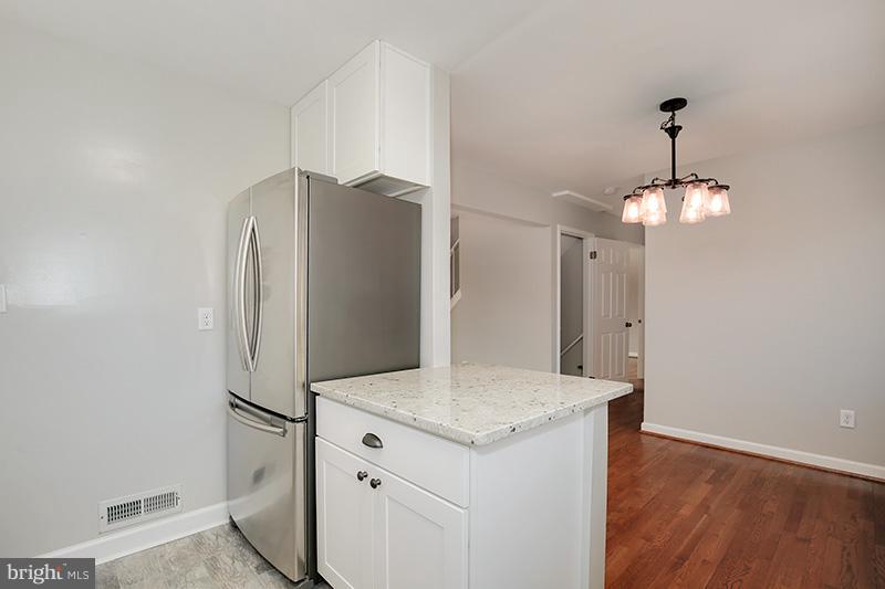 3807 Jeffry Street Silver Spring, MD 20906 - Photo 13 of 26 a kitchen with stainless steel appliances a refrigerator and wooden floor