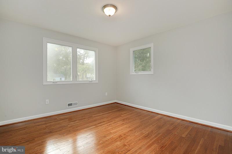 3807 Jeffry Street Silver Spring, MD 20906 - Photo 15 of 26 an empty room with wooden floor and windows