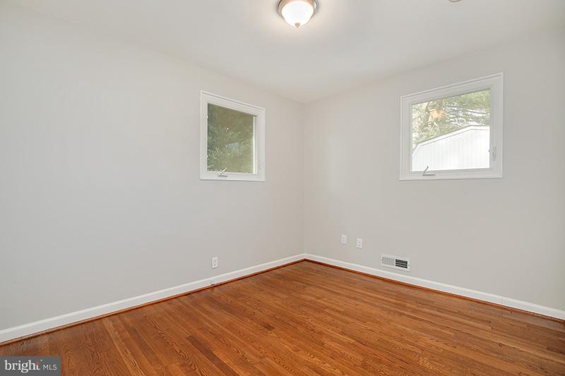 3807 Jeffry Street Silver Spring, MD 20906 - Photo 16 of 26 an empty room with wooden floor and windows
